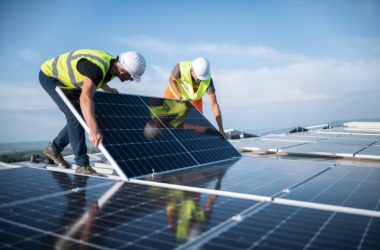 Team of two engineers installing solar panels on roof. Team of two engineers installing solar panels on roof.